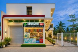 a store with a sign in front of a building at Green Meadows Residence Naga in Milaor