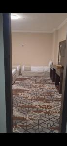 a room with a bed and a tile floor at فندق روشن كدي in Al Masfalah