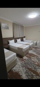 a large room with couches and pillows in it at فندق روشن كدي in Al Masfalah