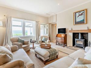 a living room filled with furniture and a fireplace at Upper Hillside Cottage in Blairgowrie