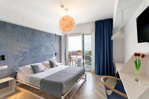 a bedroom with a bed with a blue accent wall at Haddar Etna in Zafferana Etnea