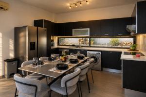 a kitchen with a dining room table and chairs at Blue Infinity Villa 33 in Neo Chorio