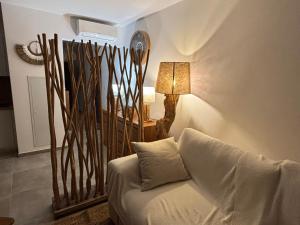 a living room with a couch and a lamp at A Isula Paradisu - Classé 4 étoiles in LʼÎle-Rousse +37 photos