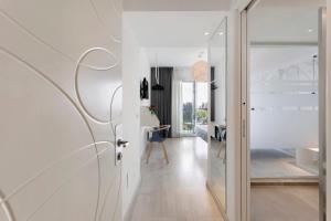 a hallway with white walls and a glass door at Haddar Etna in Zafferana Etnea +39 photos