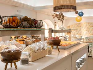 a kitchen with a buffet of food on a counter at Ona Garden Lago in Port d'Alcudia