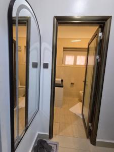 a bathroom with a mirror and a toilet at Paramount Boutique Hotel in Entebbe