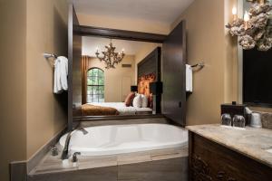 a bathroom with a large tub and a bed at Bohemian Hotel Savannah Riverfront, Autograph Collection in Savannah +28 photos