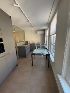 a bathroom with a glass table and a sink at Zwols stadshuis in Zwolle