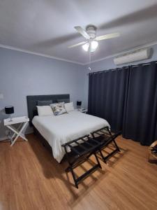 a bedroom with a bed and a ceiling fan at 25 on Union in Strand
