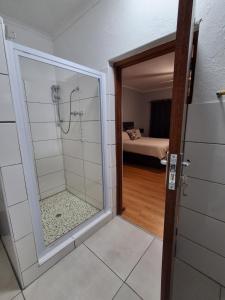 a bathroom with a shower with a glass door at 25 on Union in Strand +58 photos