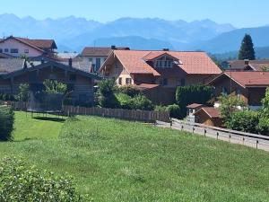 a group of houses with mountains in the background at Ferienwohnung Stoll Helga in Burgberg +10 photos