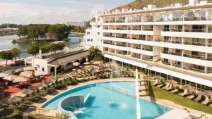 a large building with a swimming pool next to a building at Ona Garden Lago in Port d'Alcudia