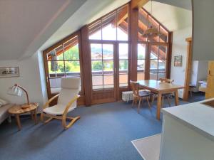 a living room with a table and chairs and a large window at Ferienwohnung Stoll Helga in Burgberg
