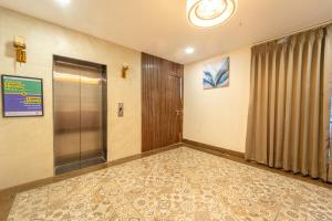 an empty room with a elevator and a door at Treebo Golden Palm, Civil Lines in Jabalpur