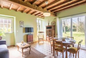a living room with a table and chairs at Gîte Les Fresnes in Sainte-Honorine-des-Pertes