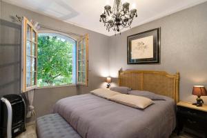 a bedroom with a large bed and a window at La Table De Pierre - Chambre d'Hôte in Lussas-et-Nontronneau +55 photos