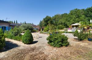 a garden with trees and bushes in a yard at La Table De Pierre - Chambre d'Hôte in Lussas-et-Nontronneau