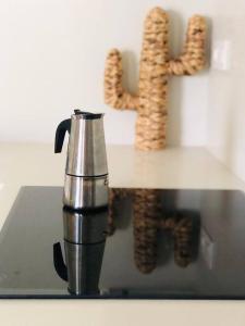 a coffee pot and a sign with the word wine at Paraísos de Agaete in Puerto de las Nieves