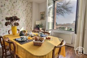 a dining room with a table and a window at Kermaria la maison d'hôtes in Plougrescant +17 photos