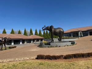 a statue of an elephant standing in a courtyard at 2nd Cozy Corner in Highlands