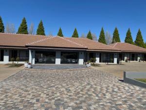 a building with a brick driveway in front of it at 2nd Cozy Corner in Highlands +9 photos