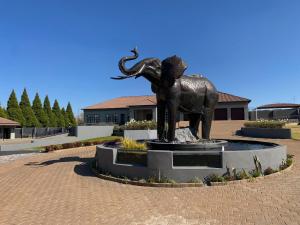 a statue of an elephant standing in a courtyard at 2nd Cozy Corner in Highlands