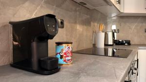 a coffee maker sitting on a counter next to a can of coffee at Bistro 49 Luxury suites in Katerini