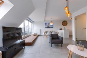 a living room with a couch and a dining room at Whaaw Oostende in Ostend