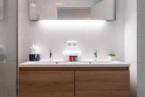 a bathroom with a white sink and a mirror at Whaaw Oostende in Ostend +32 photos
