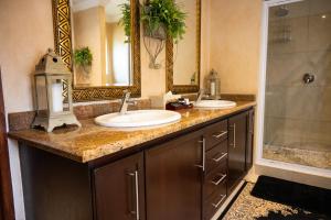a bathroom with two sinks and a shower at Tuscan Rose in Bloemfontein +62 photos