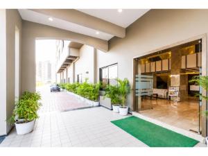 a hallway with potted plants in a building at Hotel Park Premium With Restaurant & Banquet Ujjain - By D S Stay Group in Ujjain