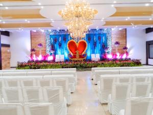 a wedding hall with white chairs and a heart altar at Hotel Park Premium With Restaurant & Banquet Ujjain - By D S Stay Group in Ujjain