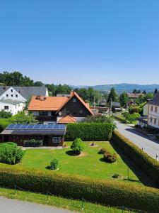 a view of a yard with a house in the background at Schullandheim Sohland Spree in Auf der Wiese