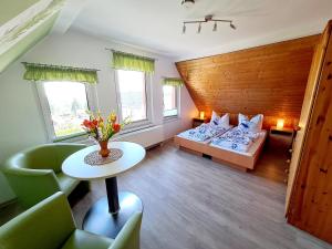 a room with two beds and a table and chairs at Schullandheim Sohland Spree in Auf der Wiese