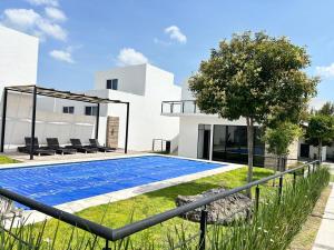 a swimming pool in front of a house at Casa en Paseo San Junipero in San José el Alto