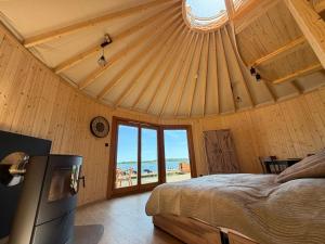 a bedroom with a bed and a view of the ocean at Forest Marina 