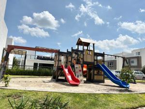 a playground with slides and a playset at Casa en Paseo San Junipero in San José el Alto