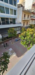 a view of a building with trees in a courtyard at Nino Suite, Central Pyrgos in Pyrgos +6 photos