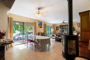 a living room with a table and a fireplace at La Table De Pierre - Chambre d'Hôte in Lussas-et-Nontronneau