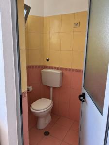 a bathroom with a toilet in a room at Beachside Apartments Smajlaj in Velipojë +31 photos