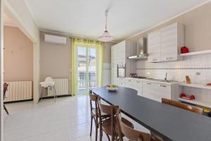 a kitchen with a table and chairs in a room at Appartamento Rina Centro Sicilia in Pietraperzia