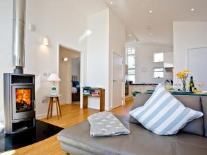 a living room with a couch and a fireplace at Una Argentum 61 in Carbis Bay +19 photos