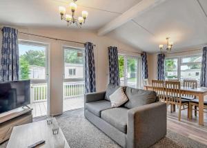 a living room with a couch and a television and a table at Thorness Bay in Porchfield +94 photos