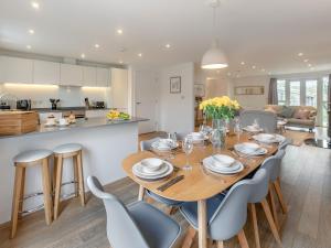 a kitchen and dining room with a wooden table and chairs at Lodge 52 Una in Carbis Bay