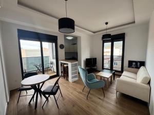 a living room with a table and chairs and a couch at Florida Apartments with PARKING in Dobra Voda