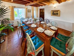 a dining room with a wooden table and chairs at Broadmeadows Farm in Butterton