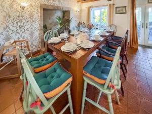 a wooden table with chairs and a dining room at Broadmeadows Farm in Butterton +25 photos