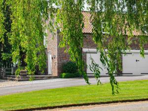 a house with two garage doors and green grass at The Granary in Aldbrough