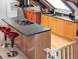 a kitchen with a stove and a counter top at The Granary in Aldbrough