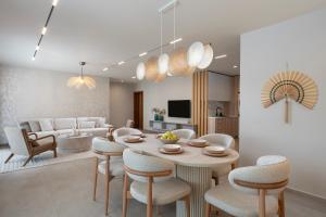 a dining room and living room with a table and chairs at Casa Real in Sveti Vlas
